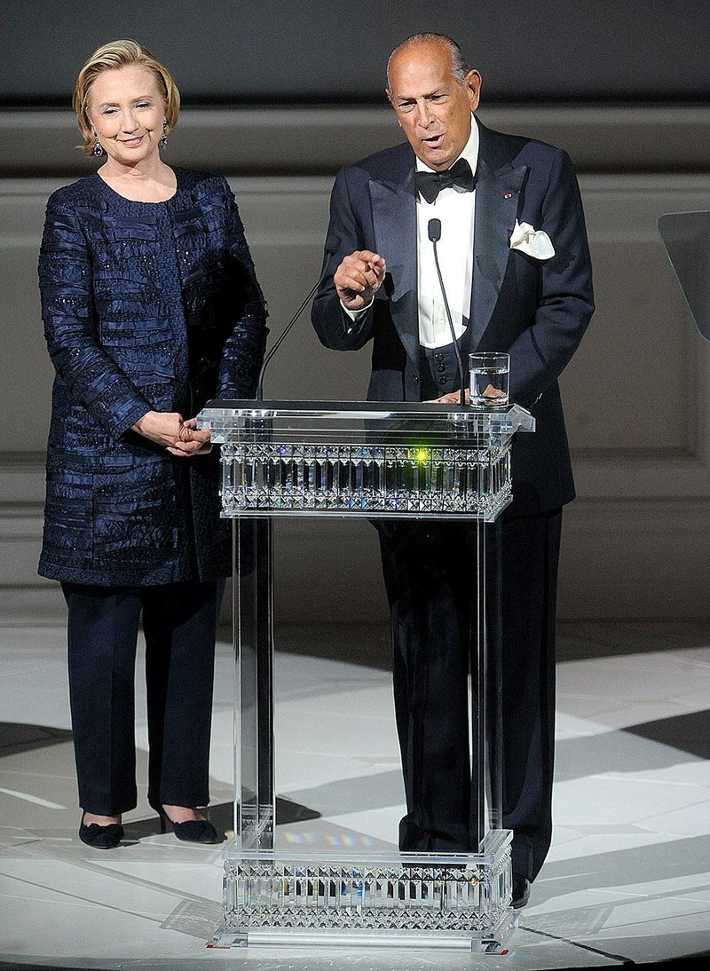 This June 3, 2013 file photo shows, former United States Secretary of State Hillary Rodham Clinton, left, and Oscar de la Renta speaking on stage at the 2013 CFDA Fashion Awards at Alice Tully Hall in New York. The designer, who died Monday, Oct. 20, 2014, at 82, shaped American couture half a century ago when it emerged as a serious rival to European fashion designers. 
