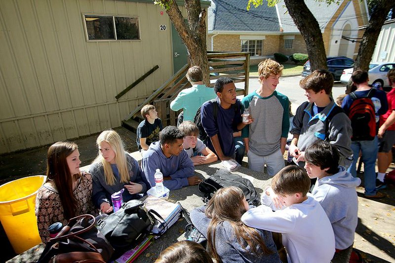 Central High School seniors eat lunch Tuesday next to some of the 21 portable classrooms on the south side of the Little Rock school. Principal Nancy Rousseau has said she’d like to see the portables replaced with a new science and technology building.