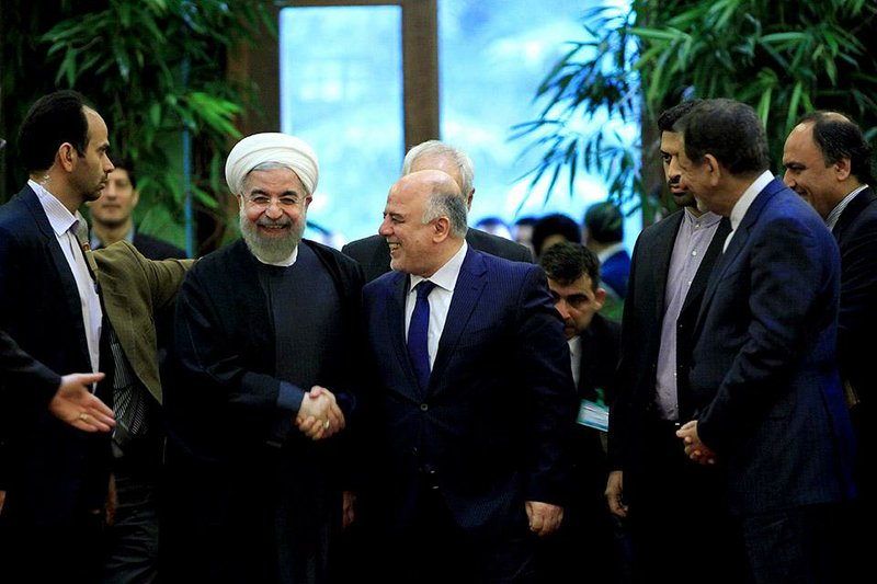 Iranian President Hassan Rouhani (left) greets Iraqi Prime Minister Haider al-Abadi at Saadabad Palace in Tehran on Tuesday.