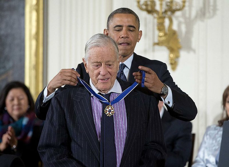 President Barack Obama awards former Washington Post Executive Editor Ben Bradlee with the Presidential Medal of Freedom in November 2013, saluting Bradlee for his intensity and dedication to journalism. 