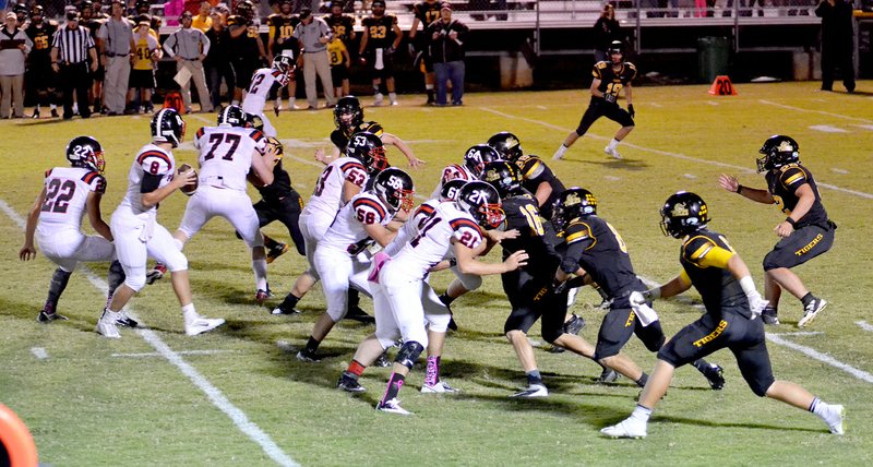 Photograph courtesy of Brea Trundle Blackhawk senior Seth Brumley, No. 8, back in the pocket for a pass, was protected by the Blackhawk offensive line Friday night during the game against Prairie Grove.