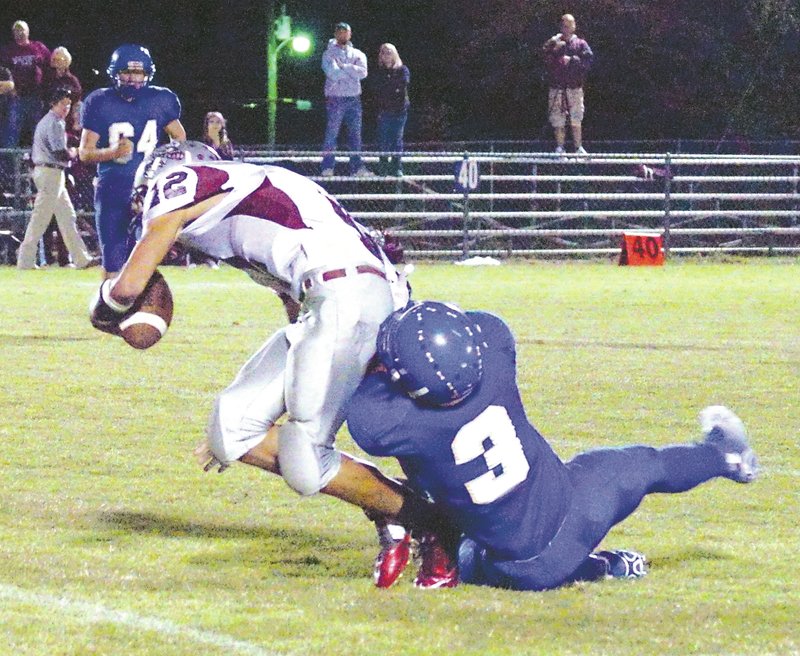 Photo by Randy Moll Decatur&#8217;s Allan Castaneda pulls down Western Yell County ball carrier Alex Thygesen during play in Decatur on Friday.