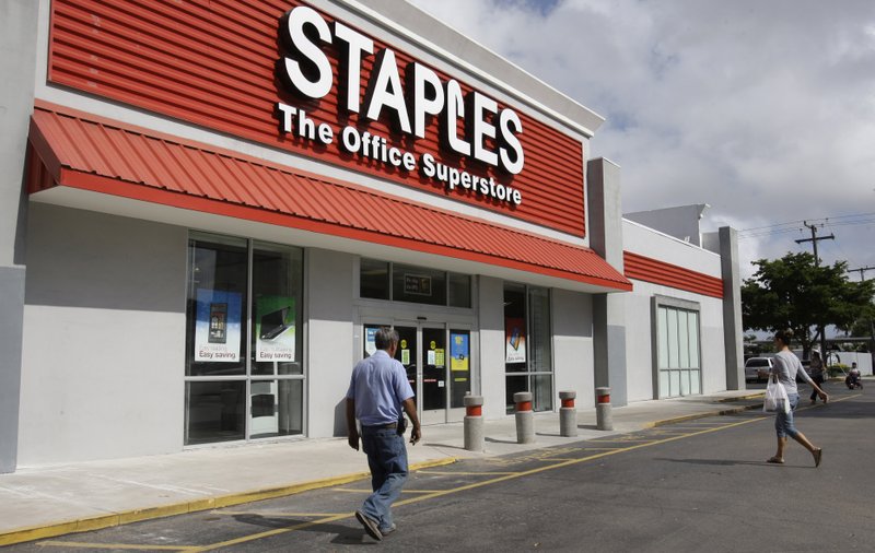  In this Tuesday, Nov. 15, 2011, file photo, customers enter Staples office supply store in Miami. Staples on Tuesday, Oct. 21, 2014 said it is looking into a potential credit card data breach and has been in touch with law enforcement officials about the issue.