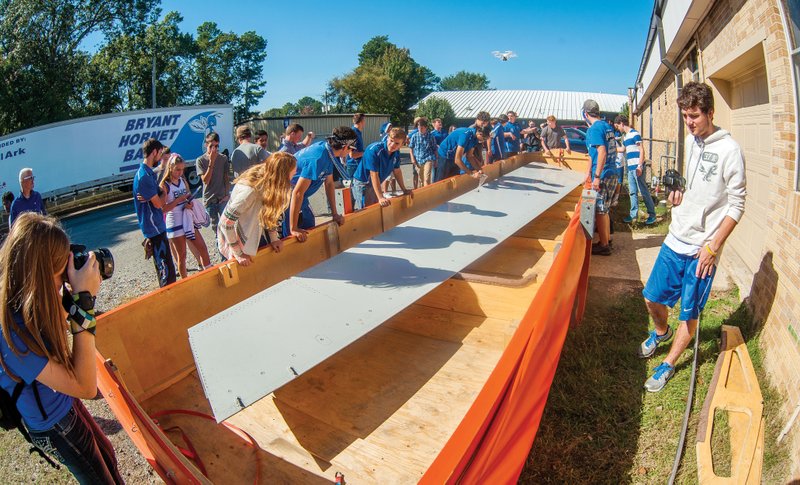 Engineering students at Bryant High School unpack a piece from an Airbus A330, the elevator from the left side of the plane’s tail section, for use in research labs and training classes in the school’s aeronautic and space program.