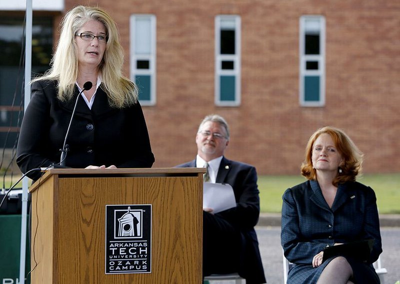 NWA Media/DAVID GOTTSCHALK - 10/23/14 -  Robin Bowen, from right to left, president of Arkansas Tech University,  and Bruce Sikes, chancellor of Arkansas Tech University-Ozark Campus, listen to Sandra Cheffer, chief financial officer of Arkansas Tech University-Ozark Campus,  during a ground breaking ceremony Thursday October 23, 2014 on the campus of Arkansas Tech University-Ozark Campus in Ozark. The ceremony was held for the new 20, 723 square-foot Allied Health building.
