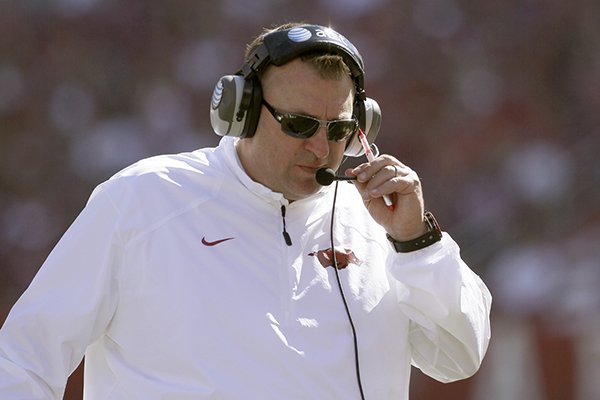 Arkansas coach Bret Bielema talks on his headset in the fourth quarter of an NCAA college football game against UAB in Fayetteville, Ark., Saturday, Oct. 25, 2014. Arkansas won 45-17. (AP Photo/Danny Johnston)