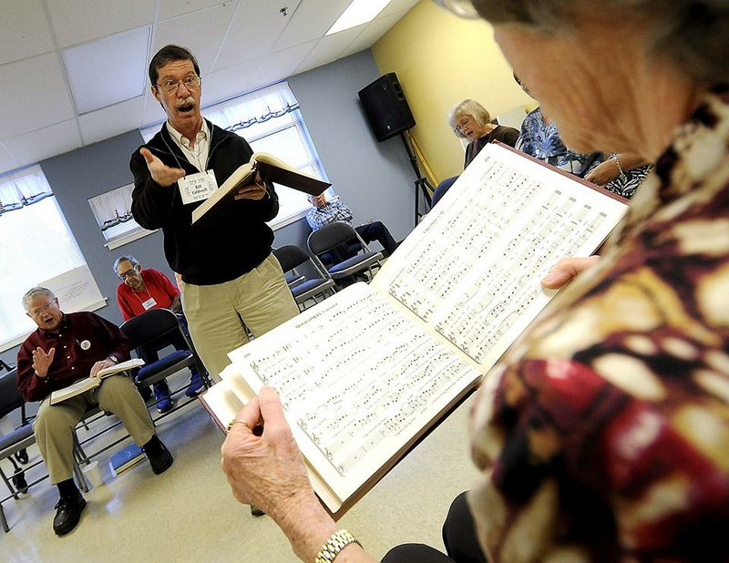 NWA Media/ J.T. Wampler - Bill Caldwell motions to Anita Buswell while leading a song Saturday Oct. 25, 2014 during the Northwest Arkansas Sacred Harp Fall Singing Convention at the First United Methodist Church in Springdale. 