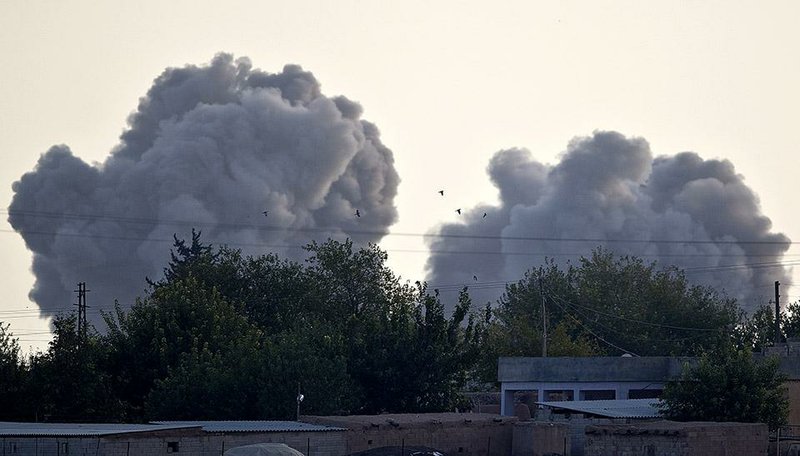 Smoke rises above the town of Kobani, Syria, after U.S.-led coalition airstrikes Saturday. Heavy fighting occurred in the city Saturday as Islamic State fighters also launched an offensive.