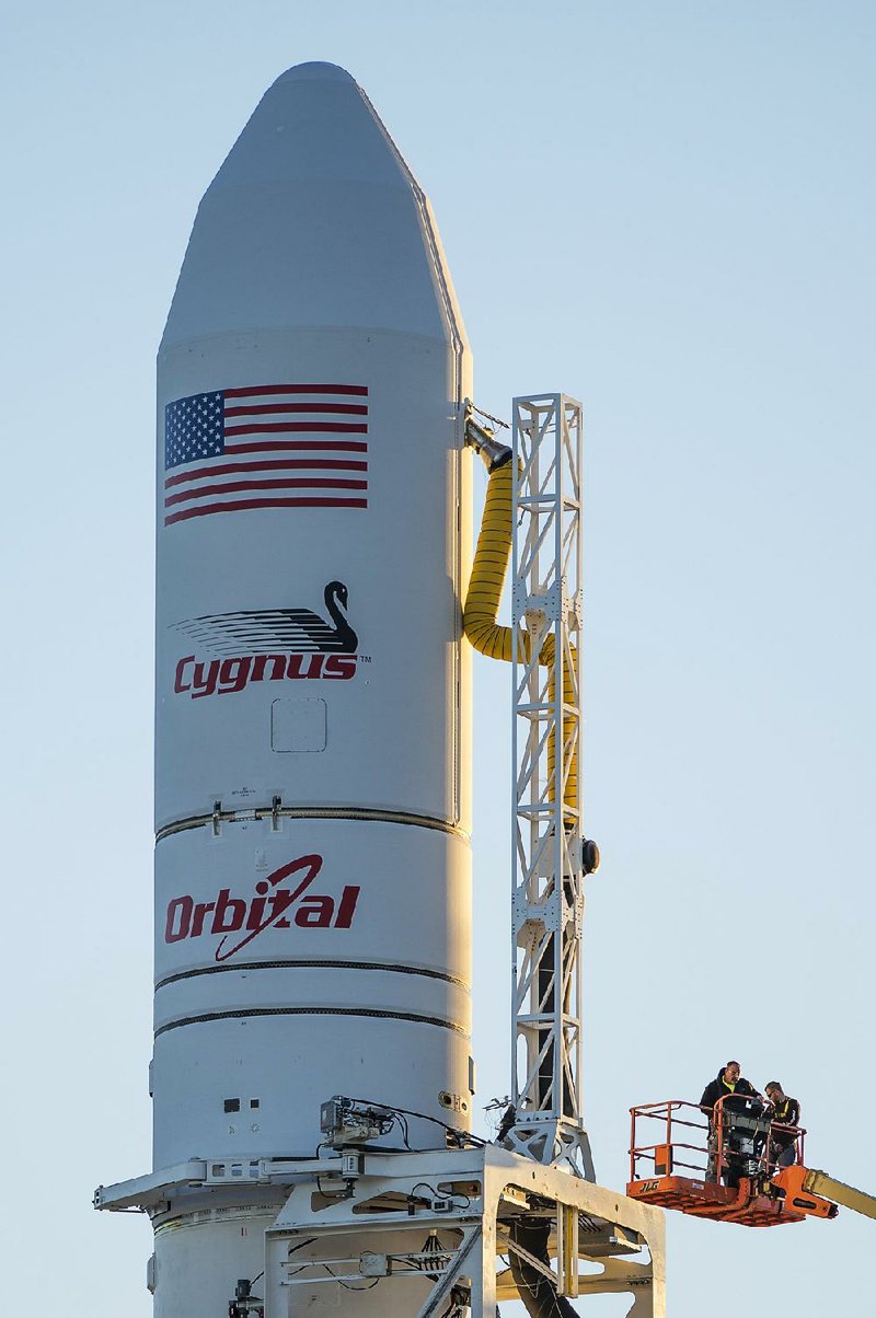 This photo provided by NASA shows the Orbital Sciences Corporation Antares rocket, with the Cygnus spacecraft onboard, Sunday, Oct. 26, 2014, at NASA's Wallops Flight Facility in Virginia. The Antares will launch with the Cygnus spacecraft filled with over 5,000 pounds of supplies for the International Space Station, including science experiments, experiment hardware, spare parts, and crew provisions. The Orbital-3 mission is Orbital Sciences' third contracted cargo delivery flight to the space station for NASA. Launch is scheduled for Monday, Oct. 27 at 6:45 p.m. EDT. (AP Photo/NASA, Joel Kowsky)