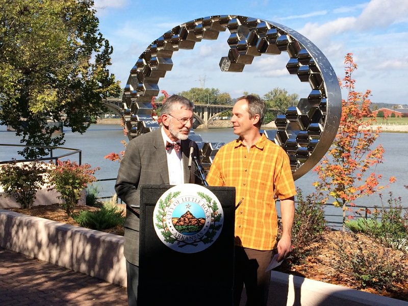 City Director Dean Kumpuris stands with sculptor Mark Leichliter at a Monday morning dedication of Leichliter's sculpture, "Through the Looking Glass," in the Vogel-Schwartz Sculpture Garden.