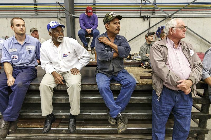 Workmen listen as Senate Minority Leader Mitch McConnell of Kentucky, a 30-year incumbent, speaks in Russellville, Ky., at H&H Sheet Metal Fabricators on Tuesday during the final week before the midterm election.