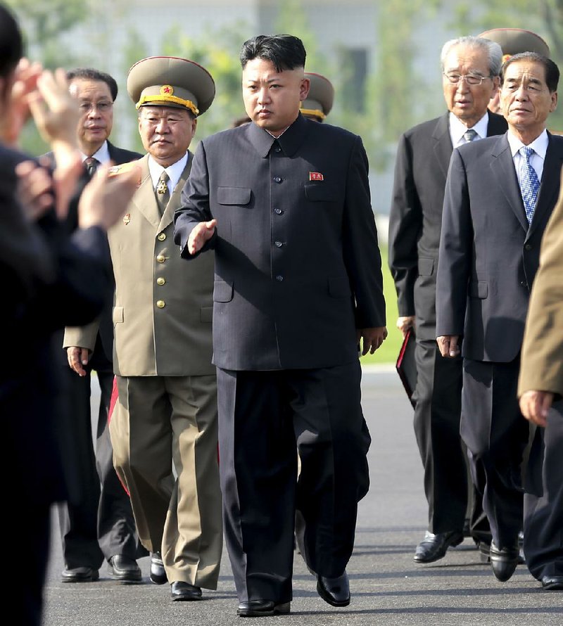North Korean leader Kim Jong Un (center), seen in the July 25, 2013 file photo, was missing from the public eye after surgery on his right ankle, according to South Korea’s spy agency.