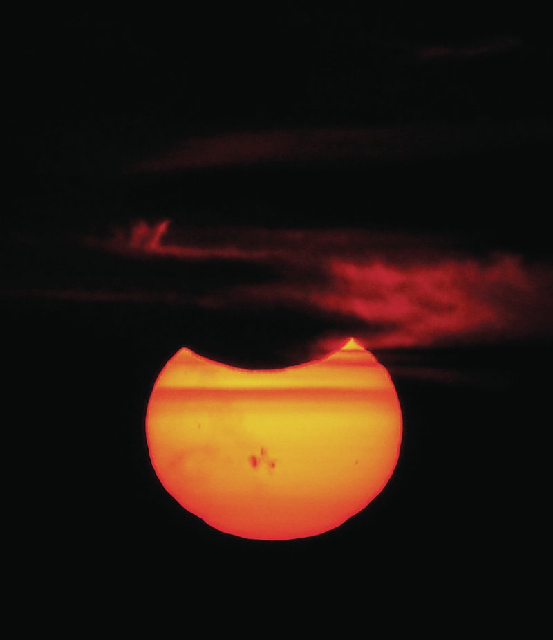 Photo by Randy Moll The solar eclipse, including sunspots, became visible in Gentry at sunset on Thursday.
