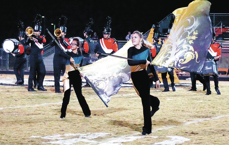 Photo by Randy Moll With the band in the background, Gravette&#8217;s flag team performed its part of a halftime routine on Friday night in Lion Stadium.