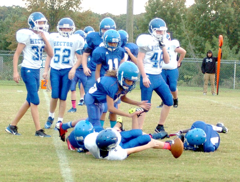 Photo by Mike Eckels When the football popped loose from a Wildcat running back, Decatur&#8217;s Tafari James (#15) made a leap over two players in an attempt to recover the ball during the Oct. 23 seventh grade game with Hector at Bulldog Stadium. James recovered the ball, which later resulted in the only score of the game.