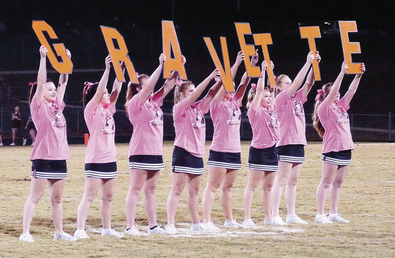 Photo by Randy Moll Gravette cheerleaders, wearing pink for a cure, led fans in a cheer during halftime Friday night in Lion Stadium.