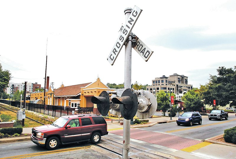FILE PHOTO DAVID GOTTSCHALK Traffic passes over the railroad crossing on Dickson Street on Sept. 16, 2013, in Fayetteville.