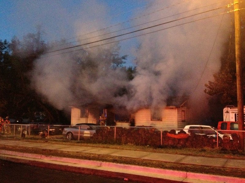 Crews work Wednesday, Oct. 29, 2014, to extinguish a house fire on Scott Hamilton Drive in Little Rock.