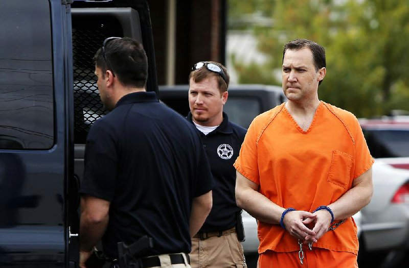 Brandon Barber is escorted out of the federal courthouse Tuesday in Fort Smith after his sentencing on federal fraud and money laundering charges. He still faces an order to pay restitution. 