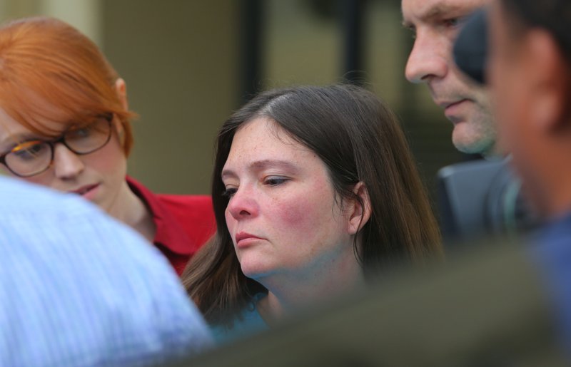 Crystal Lowery, 41, wife of murder suspect Arron Lewis, is led away from the Pulaski County sheriff's office in Little Rock on Thursday afternoon. Lowery is charged with capital murder and kidnapping in the death of Realtor Beverly Carter.