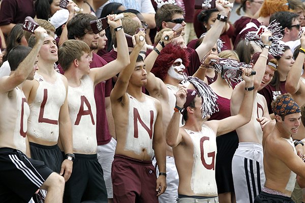 Mississippi State students wearing body paint calling for fans to clang their cowbells cheer loudly during the third quarter of their NCAA college football game against Auburn in Starkville, Miss., Saturday, Sept. 8, 2012. Mississippi State won 28-10. (AP Photo/Rogelio V. Solis)