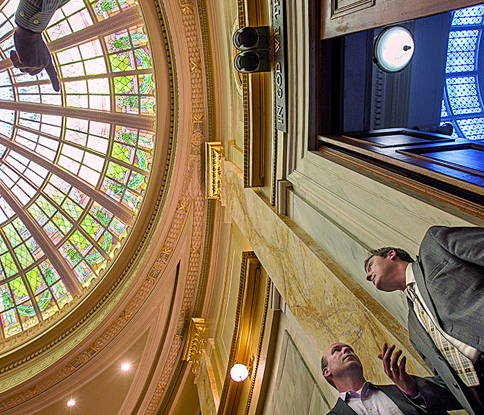 Rep. Jeremy Gillam (right), R-Judsonia, and Rep. Micah Neal, R-Springdale, examine the newly refurbished House chamber on Thursday after completion of the fi rst major restoration of the dome since it was built in 1911.
