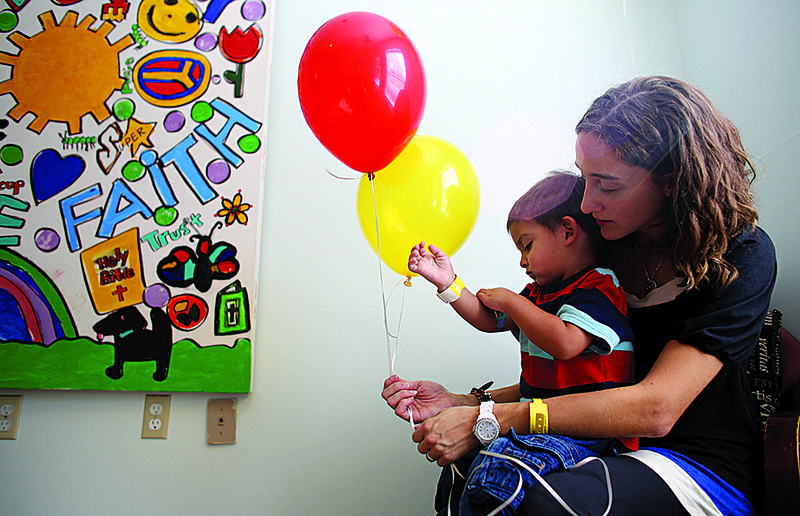 Amanda Zamarron holds son Stephen, 2, while her family checks out of the Ronald McDonald House
in Little Rock on Thursday after an overnight stay. The Zamarrons, who are from Centerton, previously
spent eight weeks at the Ronald McDonald House after Stephen was born and diagnosed with biliary
atresia, a life-threatening condition concerning bile ducts inside or outside the liver.