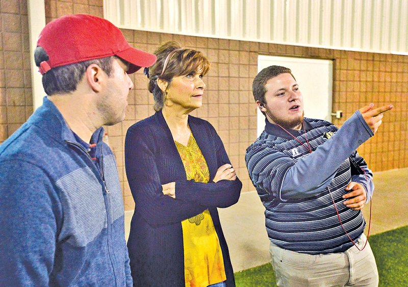  STAFF PHOTO BEN GOFF &#8226; @NWABenGoff Becky Lunney, wife of Bentonville Coach Barry Lunney, talks with son-in-law F.J. Imbo, left, and team manager Brian Salazar while watching the game against Rogers on Oct. 24 in Bentonville.