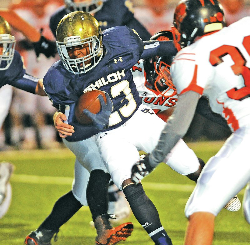 Staff Photo J.T. Wampler John-Marcus Carruthers of Shiloh Christian fights for yardage Friday against Gravette at Champions Stadium in Springdale.