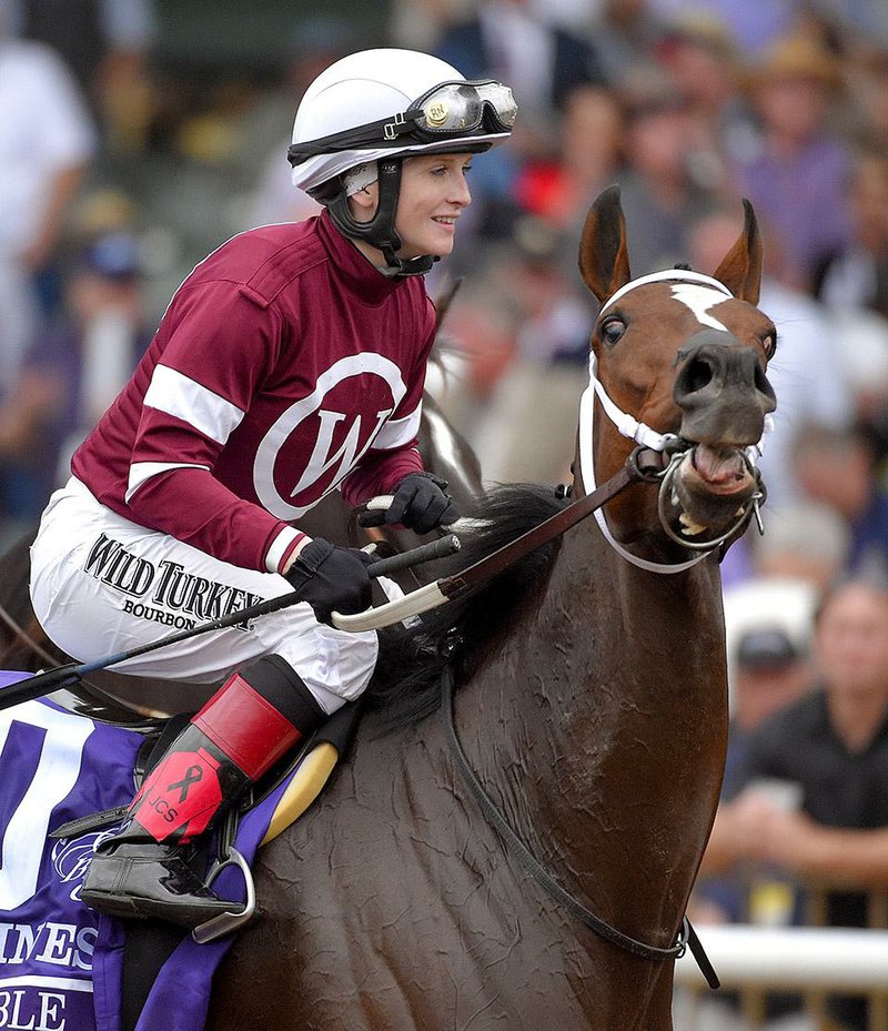Rosie Napravnik celebrates after riding  Untapable to victory in the Breeders' Cup Distaff horse race at Santa Anita Park Friday, Oct. 31, 2014, in Arcadia, Calif. (AP Photo/Mark J. Terrill)