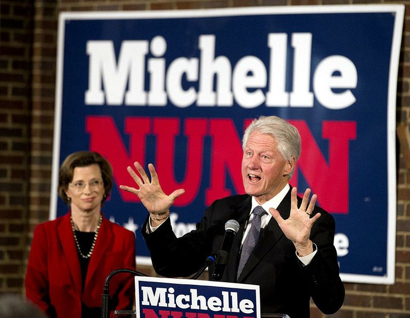 Former President Bill Clinton campaigns Friday in Atlanta for Democratic U.S. Senate candidate Michelle Nunn (left) of Georgia as campaigns across the country remain in high gear in the final days before Tuesday’s election.