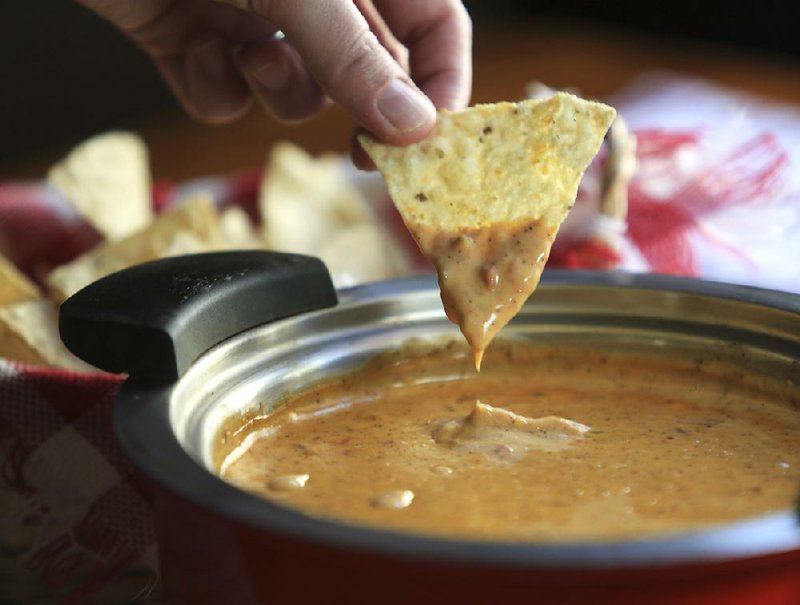 Tusk to Tail’s Cheese Dip is a tailgate party staple. The recipe combines Mexican Velveeta, tomatoes and green chiles, bean dip and spices for a creamy, piquant dip.