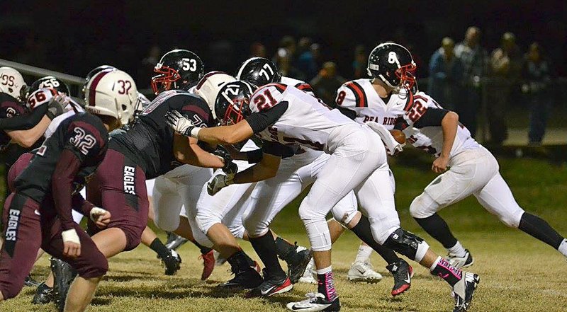 Photographs courtesy of Brea Trundle Christian Gamez, No. 53, Brent Ferguson, No. 77, and Tristan Trundle, No. 21, hold the line for Seth Brumley against the Huntsville defense.