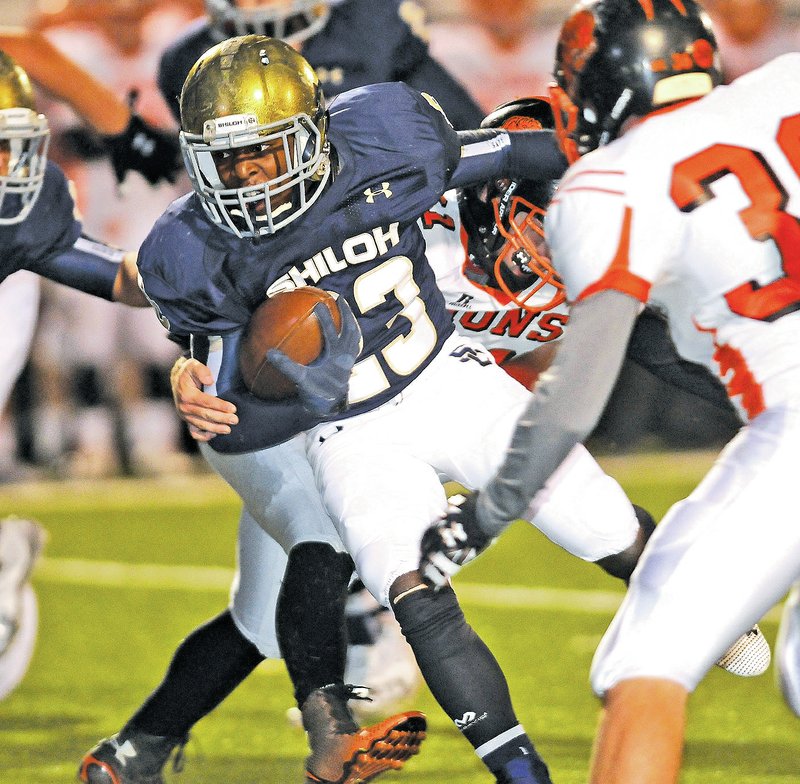  STAFF PHOTO J.T. Wampler John-Marcus Carruthers of Shiloh Christian fights for yardage against Gravette on Friday in Springdale.