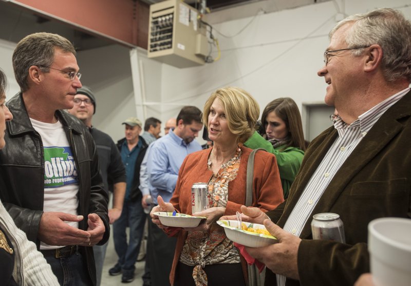Charlie Collins, left, candidate for Arkansas State District 84, talks with Mary and Robert Dennis, of Prairie Grove, at the Republican watch party Tuesday, Nov. 4, 2014 at the Washington County Republican Headquarters in Springdale.