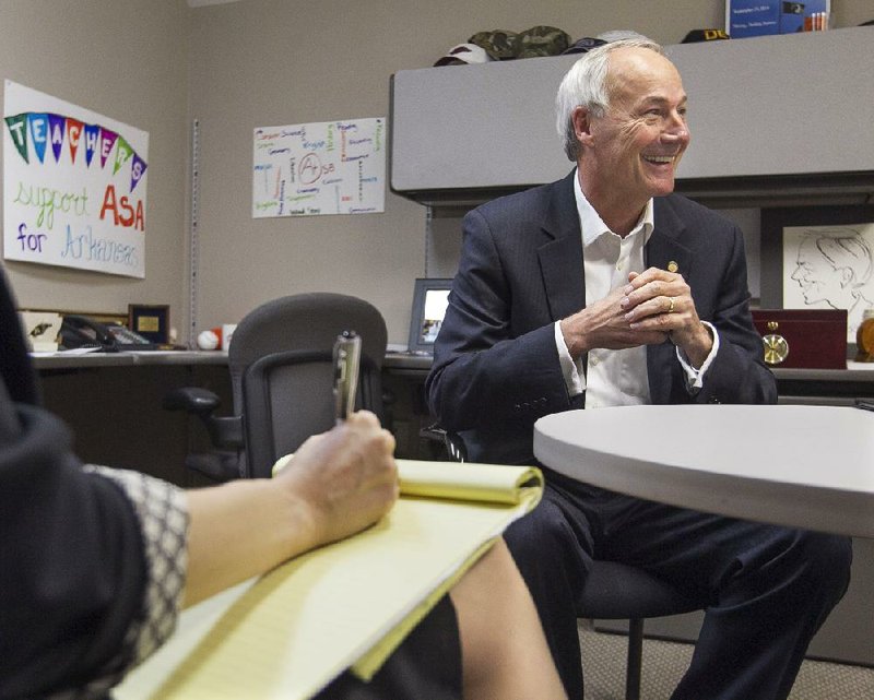 Asa Hutchinson meets with staff members Wednesday at his campaign headquarters in Little Rock as the Republican governor-elect began working on his transition with a series of meetings. 