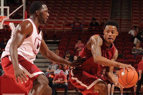 Arkansas' Anthlon Bell, right, attempts to pass around Alandise Harris during the first half of the Razorbacks' Red-White Game Wednesday, Oct. 29, 2014, in Bud Walton Arena in Fayetteville.