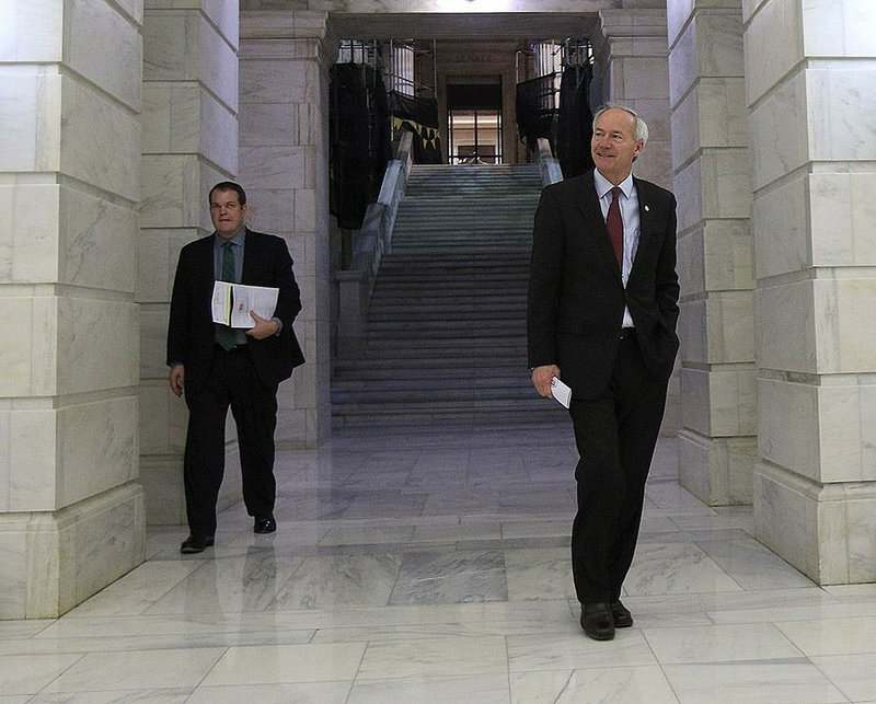  Arkansas Democrat-Gazette/STATON BREIDENTHAL --11/6/14-- Gov.-elect Asa Hutchinson (right) and Michael Lamoureux, who will serve his chief of staff, arrive at the Capitol rotunda Thursday morning for Hutchinson's press conference. 