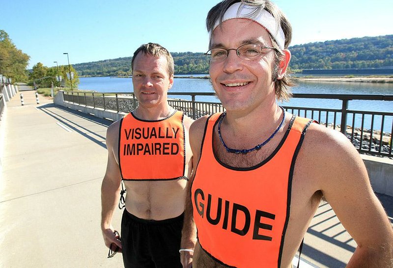 Arkansas Democrat-Gazette/fSTATON BREIDENTHAL 10/24/11
Dave Wilkinson (left) and guide Jacob Wells run regularly on the Big Dam Bridge.