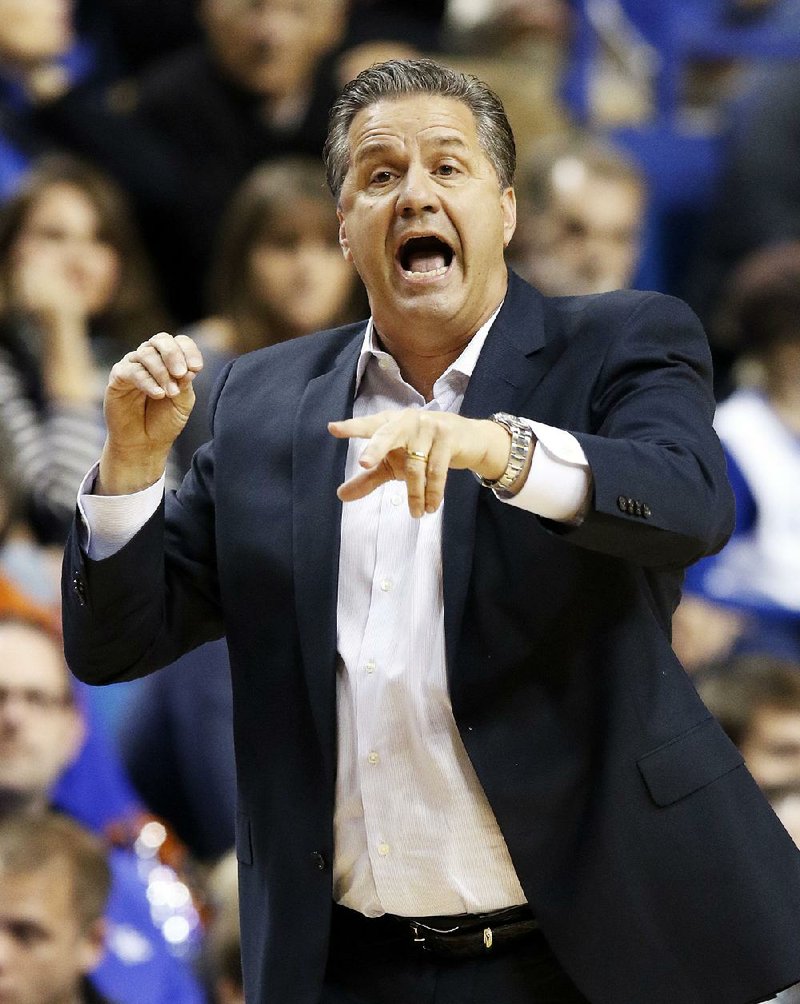 Kentucky head coach John Calipari directs his team during the first half of an NCAA college basketball exhibition game against Georgetown, Sunday, Nov. 9, 2014, in Lexington, Ky. (AP Photo/James Crisp)