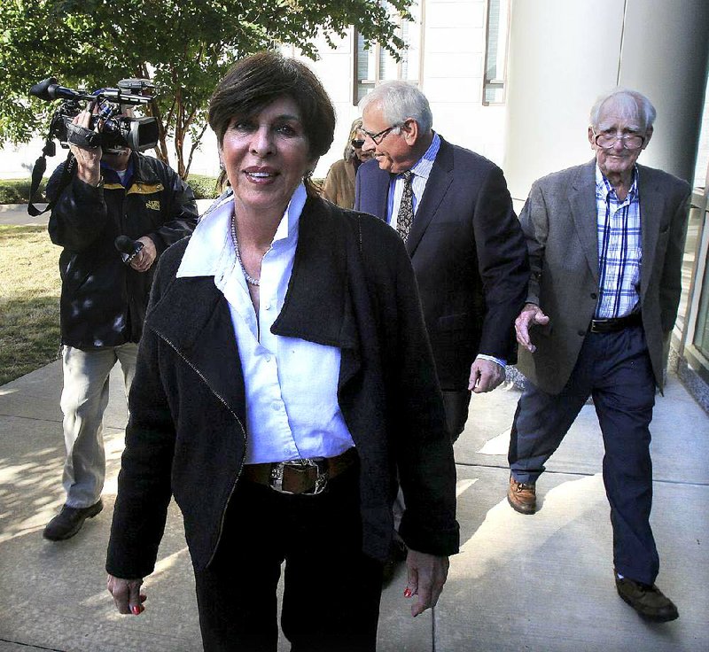  Arkansas Democrat-Gazette/STATON BREIDENTHAL --11/10/14-- Former Arkansas State Treasurer Martha Shoffner (left) arrives Monday with her attorney Chuck Banks (middle) at the federal courthouse in Little Rock.