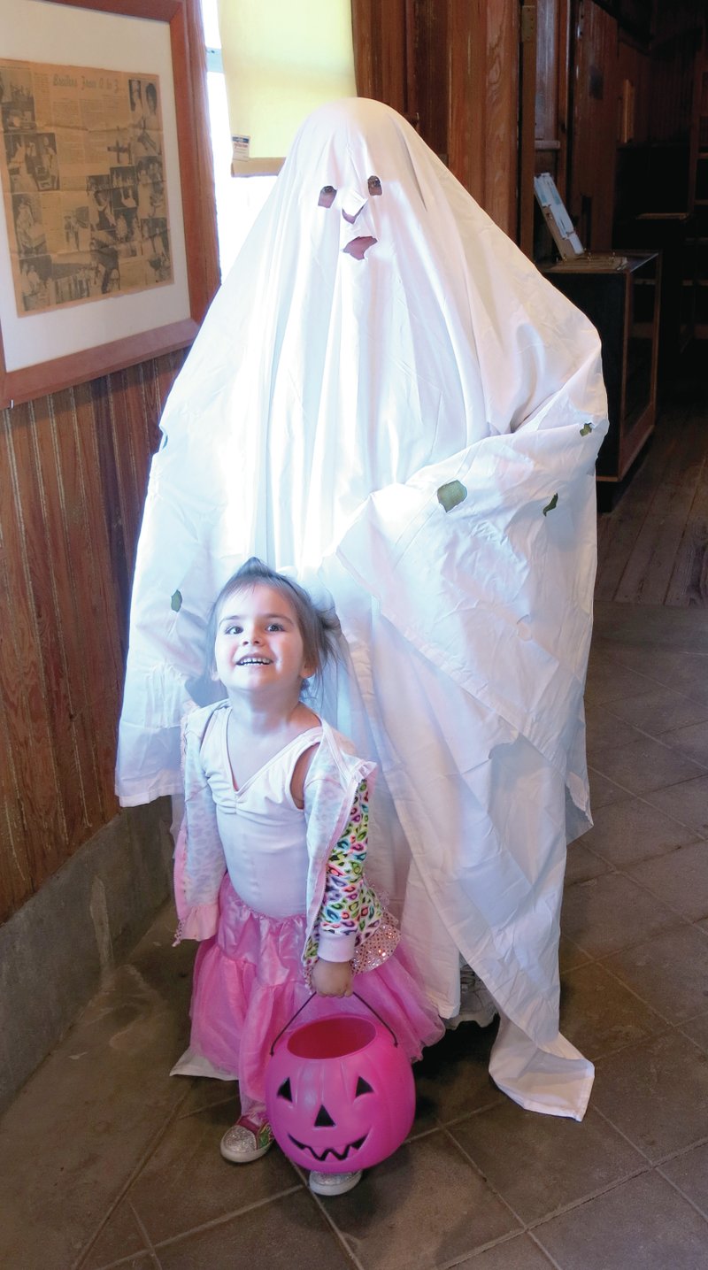 Photo by Mike Eckels Museum manager Jenelle Cox, Charlie Brown, and her niece Melody Simpson, ballerina, wait for story time at the depot. A total of 39 visitors dropped by for a piece of candy on Oct. 31.