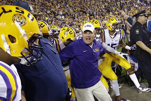 LSU head coach Les Miles leads his team onto the field before an NCAA college football game against Alabama in Baton Rouge, La., Saturday, Nov. 8, 2014. Alabama won in overtime 20-13. (AP Photo/Gerald Herbert)