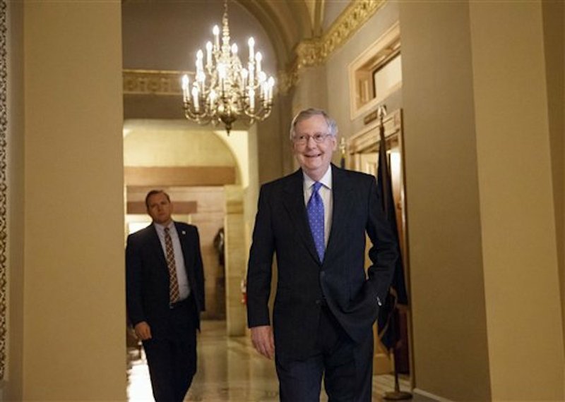 Assured of becoming the next Senate majority leader after the sweep for the GOP in the midterm elections, current Senate Minority Leader Mitch McConnell of Kentucky smiles Thursday, Nov. 13, 2014, as he arrives for a meeting on Capitol Hill in Washington of Senate Republicans to choose their leaders for the Congress that convenes in January.