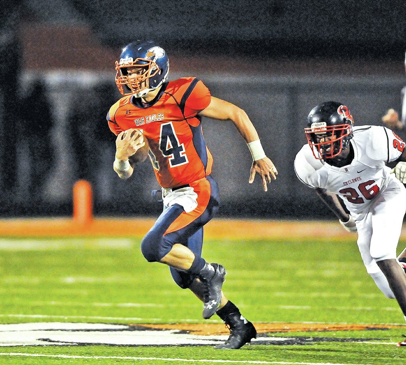  STAFF PHOTO BEN GOFF &#8226; @NWABenGoff Joel Brackett, Rogers Heritage quarterback, outruns Russellville defender Deion Stewart on his way to a touchdown in the third quarter of the Sept. 12 game at Gates Stadium in Rogers.