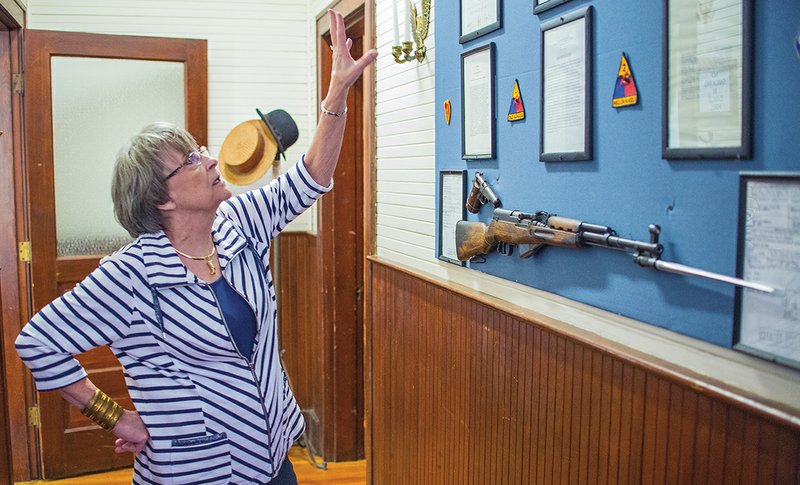 Bauxite Museum Curator Melba Shepard points to some of the items on display on the newly renovated second floor of the museum building. Shepard explained that the museum’s military memorabilia collection has grown, while area residents have also donated items related to town and school history, making the need for expansion and renovation of the facility necessary.