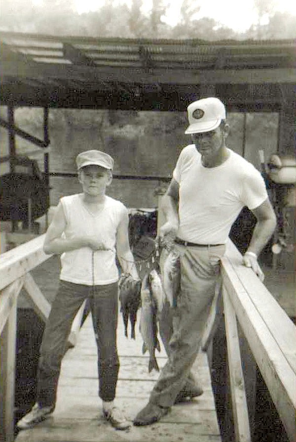 Bill Lindsey and his son, Billy, pose on the walkway down to the dock at Lindsey’s Resort. This photo was taken in the earlier years of the operation, before trout had become the fish anglers visited the Little Red River to catch. Here, the duo show off a stringer of black bass and chain pickerel.