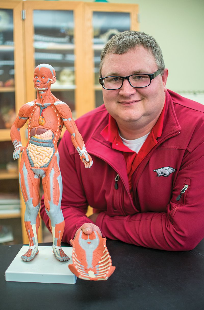 William Tremaine leans next to a model of the human body in one of the labs at Arkansas State University-Beebe as he works on his health science major after winning the Academic All-Star Award.
