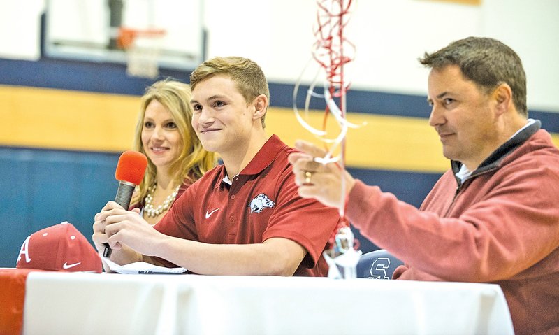  STAFF PHOTO ANTHONY REYES &#8226; @NWATONYR Jake Reindl, Shiloh Christian pitcher, smiles while thanking friends, family and coaches as his parents Missy and Brian Reindl look on Friday at the school in Springdale. Jake signed a letter of intent to play baseball at Arkansas.