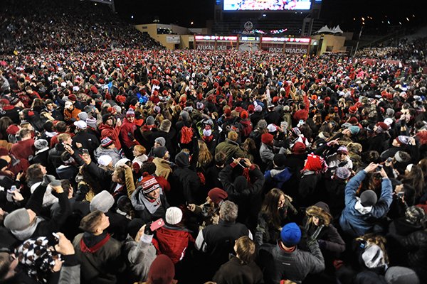 Arkansas fans rush onto the field after beating LSU Saturday, Nov. 15, 2014, at Razorback Stadium in Fayetteville.